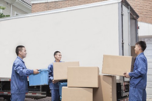 Boxes and furniture being prepared for a house move on an Irish street