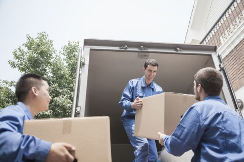 Local moving team handling furniture in a narrow Irish street