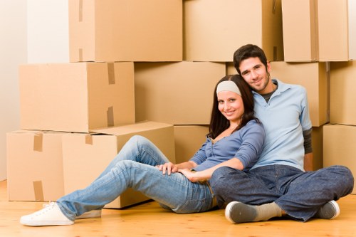 Driver loading boxes and furniture into a van for delivery