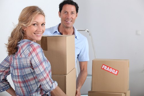 Professional movers loading household items for a domestic relocation