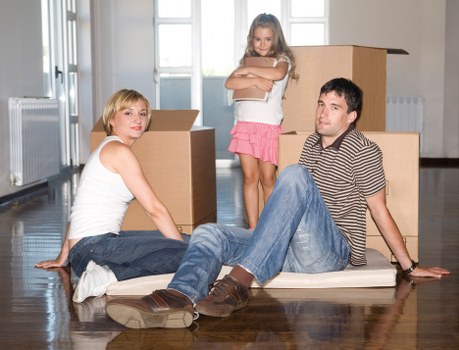Professional movers handling furniture in a city apartment